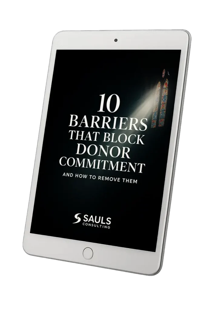 Free workbook titled "10 Barriers that Block Donor Commitment and How to Remove Them" displayed on a tablet by Sauls Consulting Services