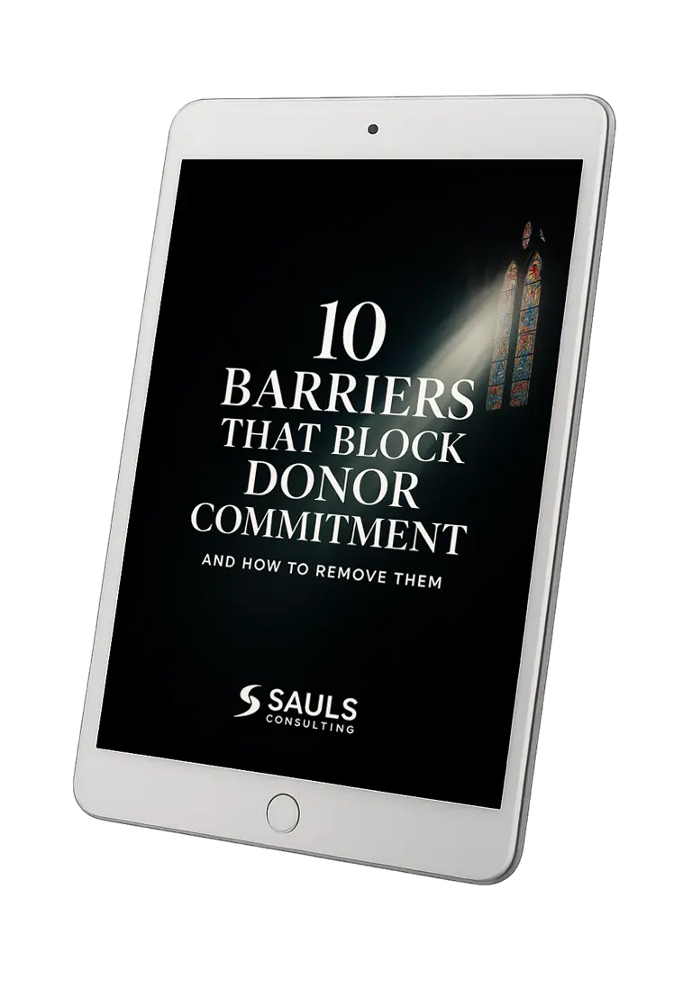 Free workbook titled "10 Barriers that Block Donor Commitment and How to Remove Them" displayed on a tablet by Sauls Consulting Services