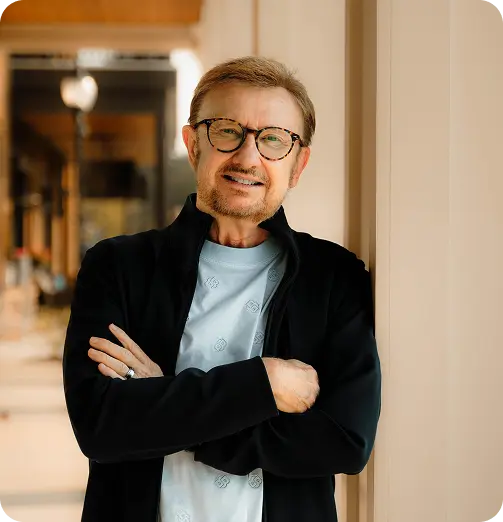 Dr. Glenn Sauls, founder of Sauls Consulting Services, standing confidently with arms crossed and smiling